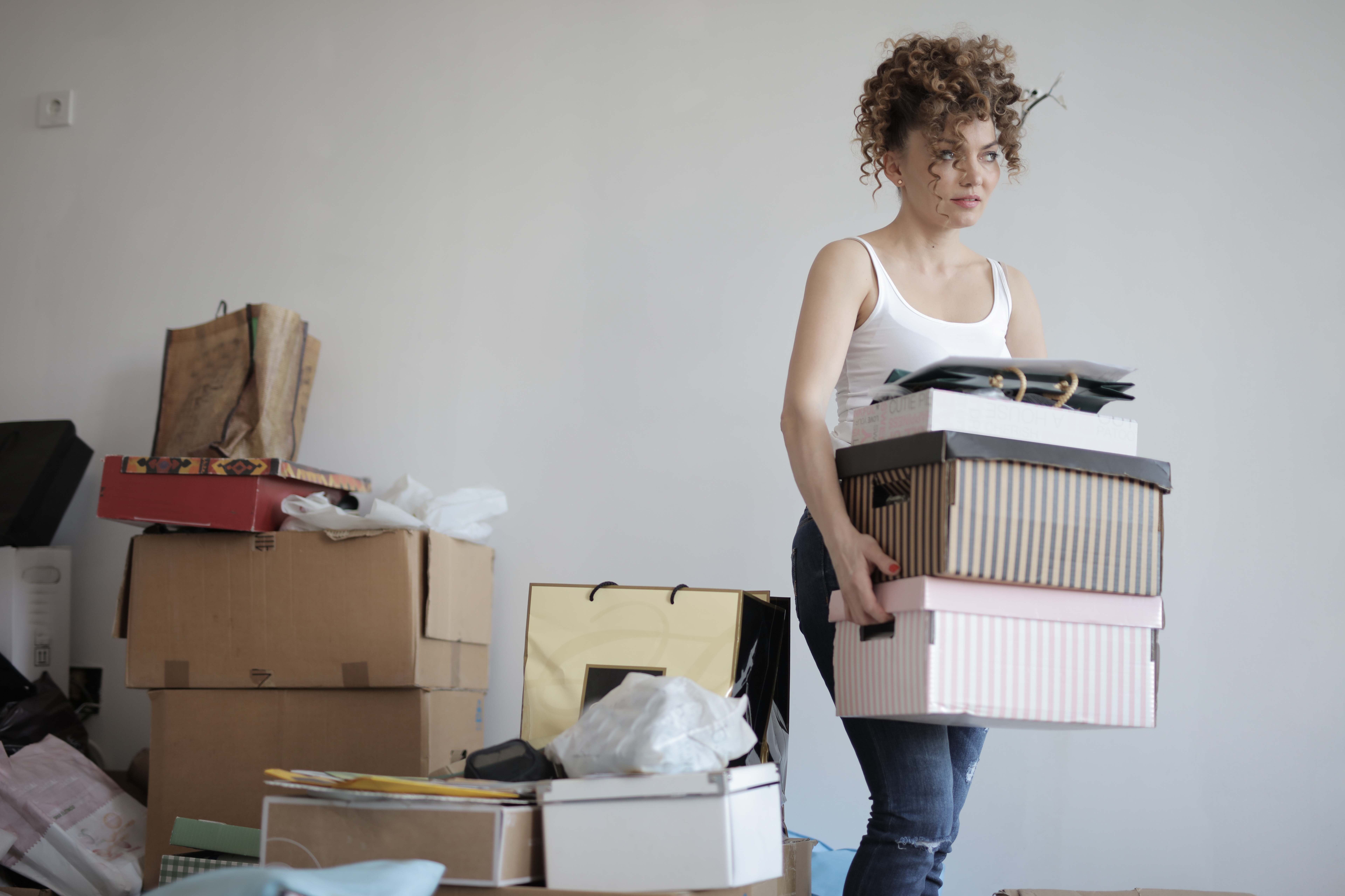concentrated woman carrying stack of cardboard boxes for 3791617
